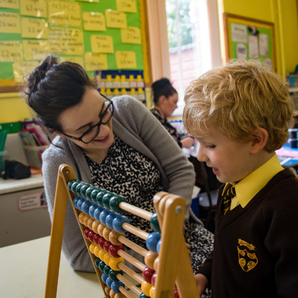 Child and teacher with abacus